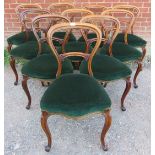 A set of ten Victorian walnut balloon back dining chairs, with acanthus carved backrests,
