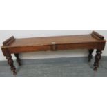 A Victorian mahogany window seat, with shaped frieze and applied roundels, on tapering turned fluted