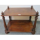 A Victorian rosewood two tier whatnot, with finials and reeded uprights, on fluted ball feet with