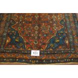 A Malayer rug, blue on red ground. Good clean rug in fine condition. 205cm x 127cm (approx).