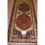 A fine Persian Heriz runner in very good condition and strong colours. 315cm x 075cm (approx).