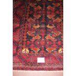 Meshed Belouch rug, a central patterned field with stylised birds, blue/deep red. Good condition and