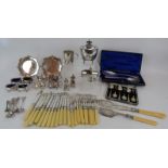 A quantity of mainly antique silver plated wares including a tea caddy, fish cutlery, condiments,