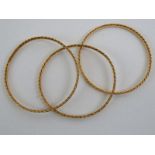 Three yellow gold high carat Omani bangles, marked '^vo', approx weight 43.7 grams, boxed. Condition
