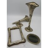 A pair of tall silver fluted vases (one a/f), Birmingham 1912, a small oval photograph frame, approx