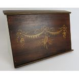 A contemporary wooden music/book rest with antique inlaid panel featuring a central design of