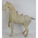 A fine Chinese Tang Dynasty pottery model of a standing horse, c. 618-907 AD, showing traces of