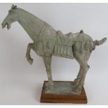 Tang style terracotta horse by Frank Johnson (1917-1998), mounted on a wooden plinth. Height 34cm.