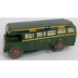 A 1950s tin plate Brimtoy clockwork Green Line bus. Length 18.5, Condition report: Some