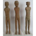 A series of three early Chinese pottery male figures, probably tomb attendants, in the Han/Tang