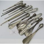 A collection of 14 silver button hooks and shoe horns. All fully hallmarked apart from one.