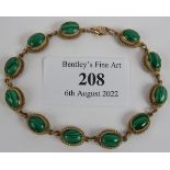 A 9ct gold and malachite bracelet consisting of 11 gold mounted malachite cabochons. Overall