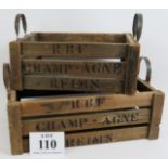 A pair of vintage style nesting wooden crates with steel strap handles, both marked 'R B F Champagne