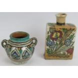 A hand decorated Iznik pottery flask and a similar Eastern small amphora. Tallest 17cm. (2).