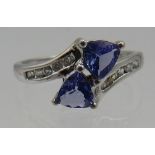 A 9ct white gold trilliant faceted tanzanite ring, size N. Good cut, colour and clarity. Condition