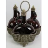 A 19th century three decanter tantalus of basket weave form with hand blown brown glass chestnut