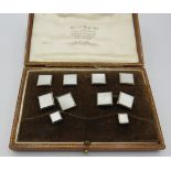 A cased set of 9ct and 18ct gold and mother of pearl studs and cuff links, Wilson & Sharp Ltd,