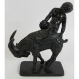 An Austrian cast iron figure of a putti and goat with painted black finish. Marked to base:
