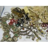 A large collection of mainly vintage jewellery to include a white metal decorative belt, white metal