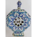 An antique Indo-Persian Iznik pottery reticulated flask with blue and white decoration. Height 24cm.