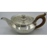A Georgian silver teapot with wooden handle, London 1815, William Burwash, approx weight 19.8