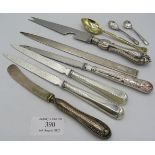 A silver paper knife, three silver handle paper knives, a silver handled cheese knife, silver