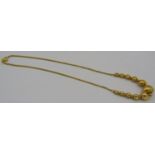 A 22ct yellow gold necklace with a row of graduated gold balls. The 'S' shaped clasp marked 916