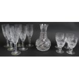 A boxed set of six Waterford crystal champagne flutes in Colleen pattern, four small wine glasses in