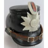 A Cold War era German police leather shako helmet bearing the badge of North Rhine-Westphalia.