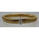 A Roberto Coin 18ct Italian gold flexible bracelet with a white gold collar set with 26 brilliant