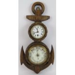 An early 20th century aneroid barometer and clock in a carved oak anchor shaped case. Height 54cm.