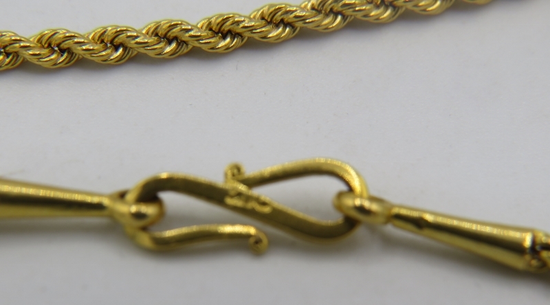 A yellow metal rope twist necklace with 'S' shaped clasp having indistinct marks. Probably Omani, - Image 2 of 2