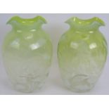 A pair of antique graduated green Vaseline glass vases with foliate design. Ground pontils to bases,