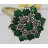 An 18ct gold diamond and emerald cluster ring, diamonds approx 0.6cts, and emeralds 1.15cts, size M.