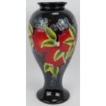 A large pottery vase with grape and pomegranate design in the style of William Moorcroft.