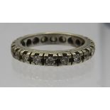 A diamond & white metal eternity ring containing twenty diamonds, total 0.6cts approx, size N.