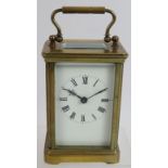 A small brass cased 8 day carriage clock with enamel dial. Height 15cm. No key. Condition report: