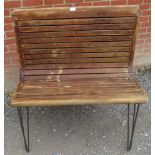 A vintage French double sided tram seat of slatted wood form later converted with contemporary steel