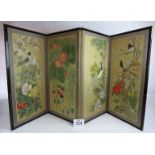 A 20th century four panel folding oriental silk screen with hand painted decoration of birds,