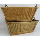 Two large wicker log/laundry baskets with handles and wooden bearers. Length 75cm. Width 48cm. Depth