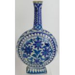 An antique Indo-Persian Iznik pottery moon flask with blue and white floral decoration. Marked to