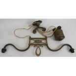 An early 20th century brass rise and fall ceiling light fitting with two bulb holders. Width 60cm.