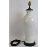 A tall white porcelain baluster lamp base with black metal mounts. Overall height 56cm. Condition