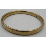 A 9ct yellow gold bangle, approx weight 20.7 grams. Condition report: Some surface scratching.