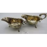 A pair of silver sauce boats with acanthus leaf decoration and on pad feet, Birmingham 1930,