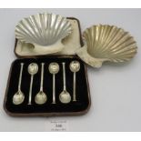 A pair of silver shell shaped butter dishes, London 1968 and a boxed set of silver coffee spoons,