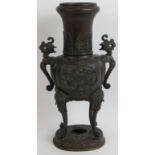 An early 20th century bronze Chinese censer on raised legs and with dragon head handles. Height