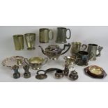 A lot of mixed pewter and silver plated wares including seven pint tankards, pin dishes, three piece