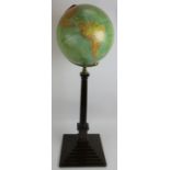 An antique style terrestrial globe on Corinthian column stand with brass axis produced by George. F.