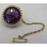 A large circular amethyst set brooch surrounded with seed pearls, amethyst approx 9.8cts, tested